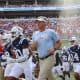 Lane Kiffin running out with Ole Miss Football.